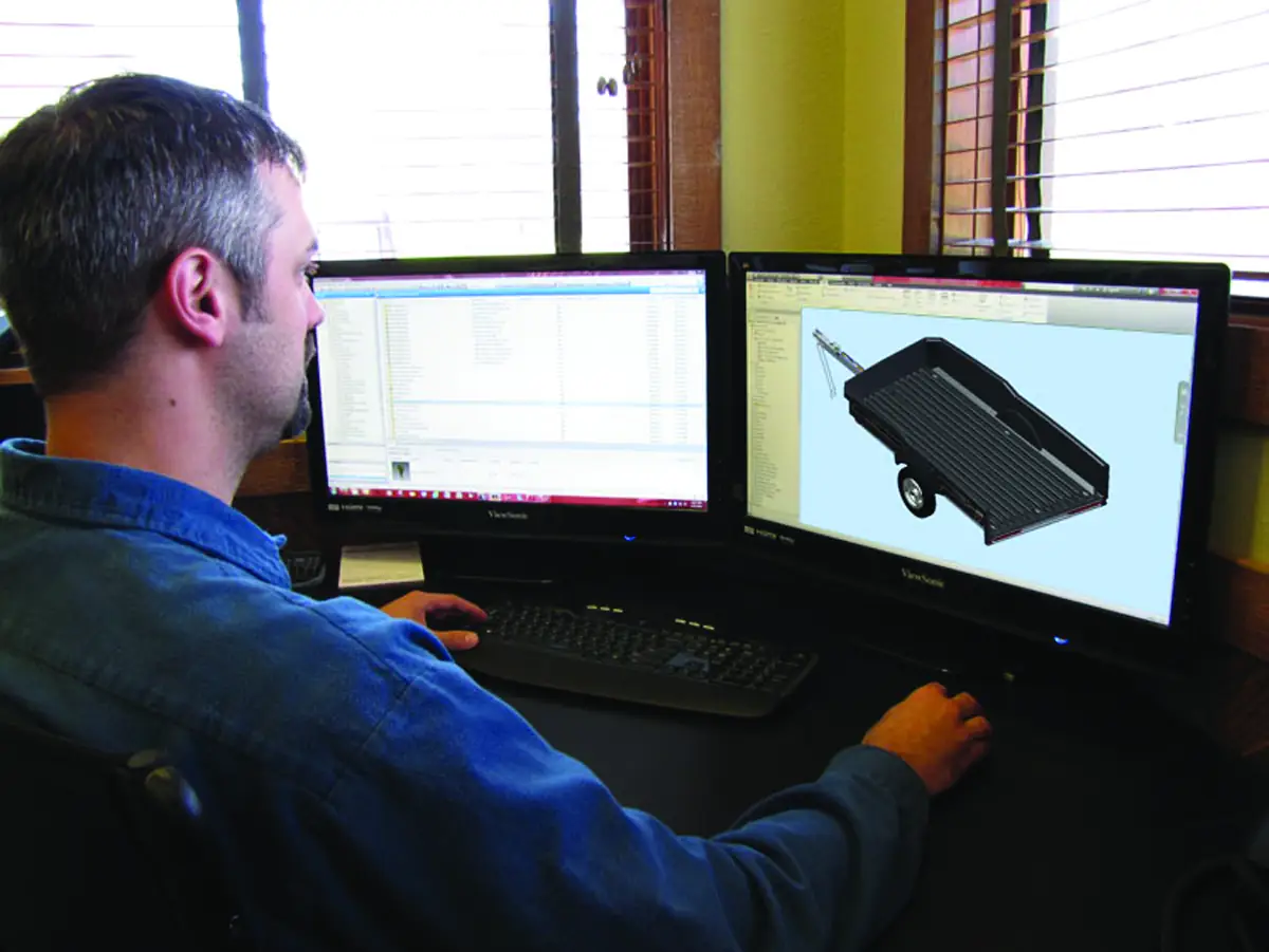 ThermoFloe engineer reviewing part geometry and tooling on a CAD workstation